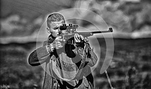 Masculine hobby activity. Hunting target. Man hunter aiming rifle nature background. Experience and practice lends