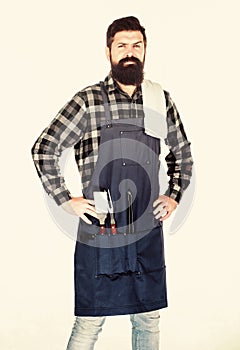 Masculine hobby. Bearded hipster wear apron for barbecue. Roasting and grilling food. Man hold cooking utensils barbecue