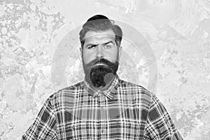 Masculine traits. Brutal bearded man concrete background. Serious man with beard and moustache. Confident hipster