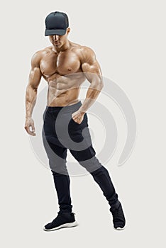 Masculine young fitness male model posing shirtless against white background