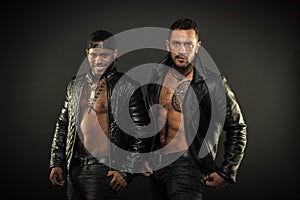 Masculinity and brutality concept. Men with sexy muscular torsos look brutally. Machos with muscular torsos look