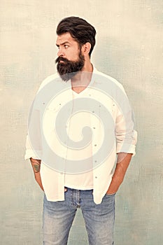Masculinity concept. Hipster long beard and mustache. Male temper brutality. Brutal macho casual outfit gray background
