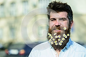 Masculinity concept. Man with beard and mustache enjoy sunny weather. Hipster on happy smiling face, urban background