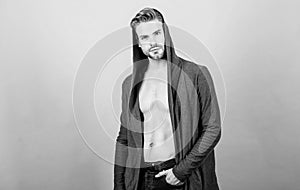 Masculinity and confidence. Man well groomed handsome hooded clothes. Unconventional but masculine look. Brute