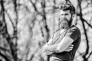 Masculinity and manliness. Man attractive bearded hipster posing outdoors. Confident posture of handsome man. Guy photo