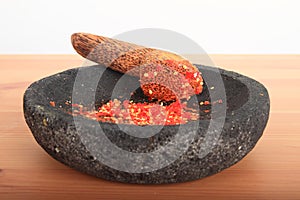 Mashed chilli paprikas in mortar