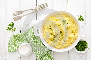 Mashed potato with butter and milk on table