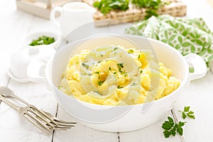 Mashed potato with butter and milk on table