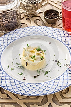 Mashed potato with dill and glass of red drink on orienral wooden table