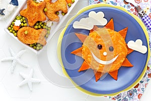 Mashed potato and pumpkin puree sun with nuggets for kids