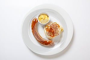 Mashed potato and roasted sausage or bratwurst on white plate