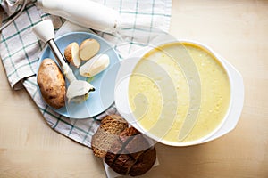 Mashed potato soup with bread on   table