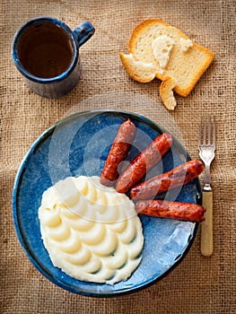 Mashed potatoes with fried sausage