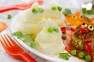 Mashed potatoes ghosts with green peas eyes, hot dinner dish for