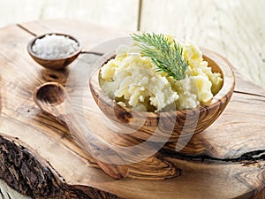 Mashed potatoes in the wooden bowl.