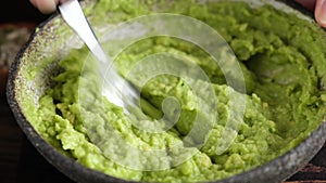 Mashing avocado in puree