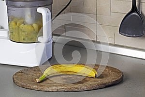 mashing bananas and apples in a food processor