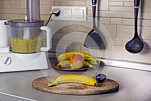 mashing bananas and apples in a food processor