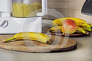 mashing bananas and apples and plums in a food processor