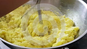 Mashing of boiled tapioca with coconut masala