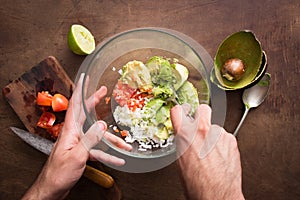 Mashing vegetables to make guacamole