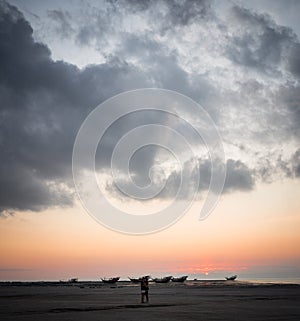 Masirah Island, Oman, December 31, 2019: beautiful image.of a loving couple hugging on the beach with boats stranded in the