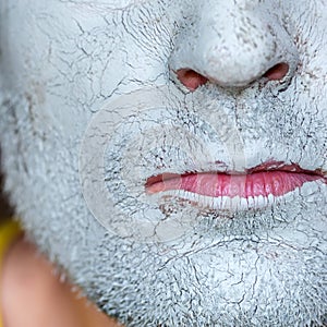 Mask of blue clay on men face