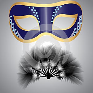 A mask and a fan made of fluffy feathers for carnival or masquerade, decorated with glittering crystals and colorful