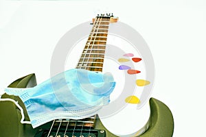 Mask,guitar and plectrums on a white background