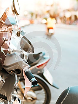 A mask hanging on a motorcycle handle to prevent germs Covid-19 on roadside in the city.