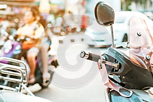 A mask hanging on a motorcycle handle to prevent germs Covid-19 on roadside in the city.