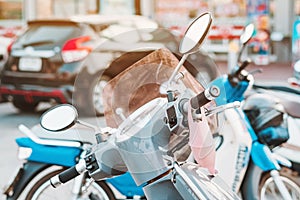 A mask hanging on a motorcycle handle to prevent germs Covid-19 on roadside in the city.