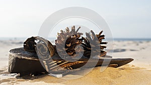 Mask made of wood on the sand near the sea