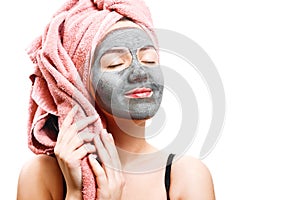 Mask for skin woman, happy girl holding a towel, girl enjoys a mask for face skin, isolated photo, closed eyes