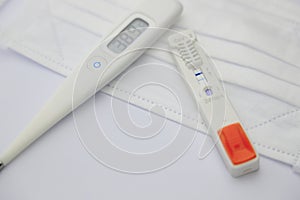Mask, thermometer and antigen test of COVD-19 photo