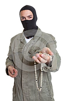 Masked burglar showing jewelry