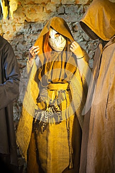 Masked and cassocked monk performs ritual pagan rite