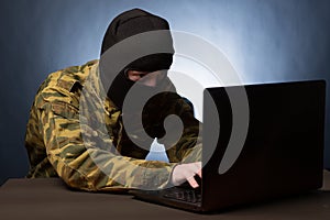 Masked cyber terrorist hacking army intelligence