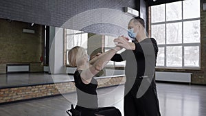 Masked dance partners during training in ballroom