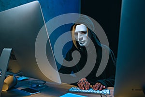 masked female hacker developing malware