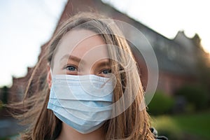 Masked girl on an empty street in the USA. Coronavirus. Pandemic epidemic. Outbreak of illness. Media and news publishers, ban on