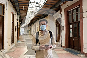 Masked male tourist walks at closed market during coronavirus pandemic, lockdown on Cyprus. Man in mask walks through