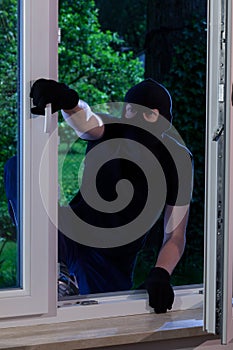 Masked man entering the house