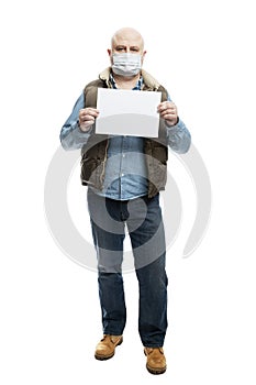 The masked man is holding an empty sheet of white paper. Precautions during the coronavirus pandemic. Isolated on a white