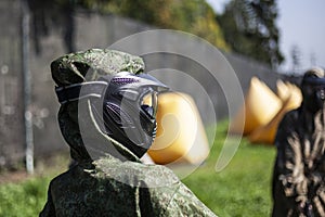 The masked man. Sports mask for playing paintball on the playerÃ¢â¬â¢s head. Black mask with safety glass. photo