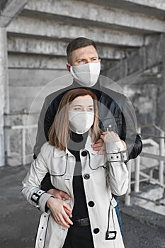 A masked man and woman embrace. Coronavirus. Covid19
