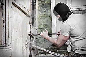 The Masked Robber Breaks the Lock Door in the House