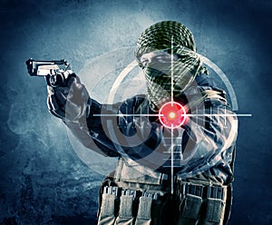 Masked terrorist man with gun and laser target on his body