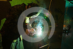 Masked worker doing spot welding work