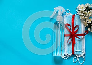 Masks and antiseptics on a blue background.